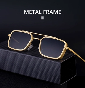 Detail of square pilot metal sunglasses on a premium black leather texture case