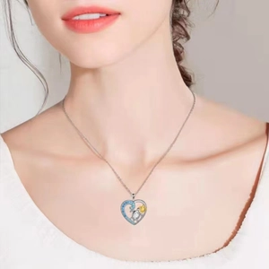 Silver heart necklace with sea turtle and blue zircon crystals on mannequin neck