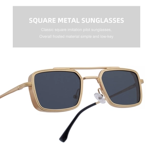 Detail of square gold metal sunglasses with frosted frames and dark grey lenses