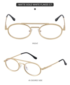Detail view of matte gold oval frames with vintage double bridge and clear lenses