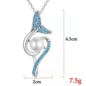 Detail of mermaid tail pearl pendant with blue zircon stones measuring 4.5cm by 2cm