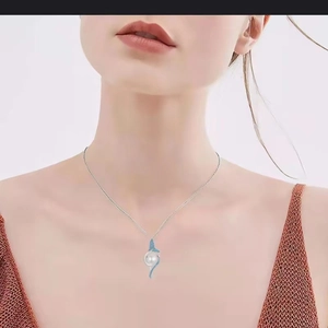 Elegant mermaid tail pearl necklace with blue enamel on a female model