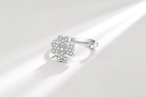 Macro shot of rotatable clover ring with sparkling cubic zirconia on a light background