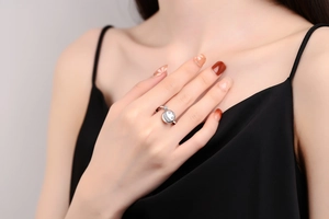 Macro detail of silver star and moon spinner ring with zircons on model's hand