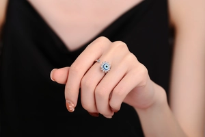 Close-up of adjustable silver evil eye ring with sparkling cubic zirconia on model finger
