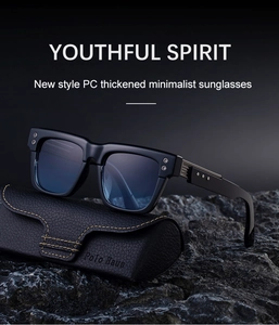 Detail of square frame sunglasses on rock base with leather case and yellow stitching
