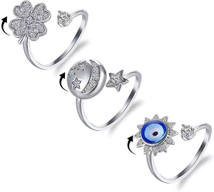 Detail view of rotatable anxiety rings with clover and evil eye zircon designs