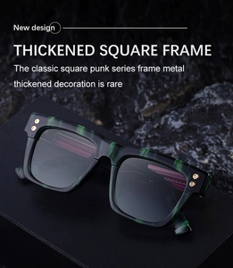 Close-up of thick square sunglasses with green cloud pattern and gold hexagonal rivets