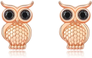 Detail of rose gold owl earrings with black gemstone eyes and textured feathers