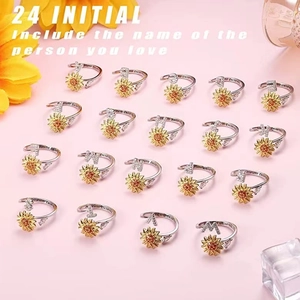 Detailed shot of sunflower letter rings with You Are My Sunshine engraving on band