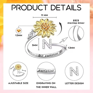 Macro detail of S925 sterling silver spinning sunflower ring with letter N engraving