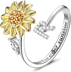 Close-up of spinning sunflower ring with letter R and You are my sunshine engraving