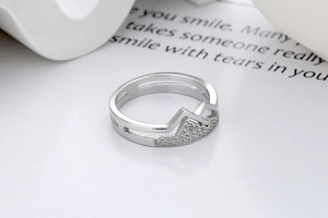 Detailed view of silver mountain ring with double band and micro-set zircon accents