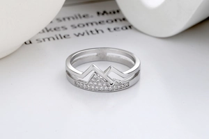 Macro view of mountain-shaped ring with pave-set zircon stones on hollow band