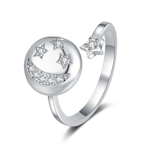 Adjustable silver spinner ring featuring sparkling cubic zirconia star and moon charms