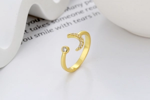 Detail of adjustable gold moon ring with micro-set zircon and round stone