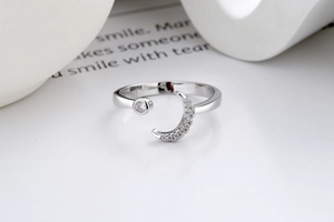 Detailed close-up of crescent moon and star ring with sparkling zircon stones