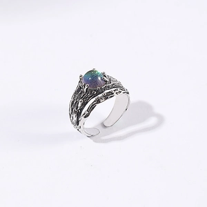 Macro detail of vintage adjustable ring with irregular texture and iridescent stone