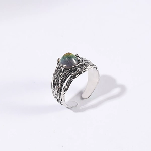 Close-up of vintage moonstone open ring with realistic bark texture in antique silver
