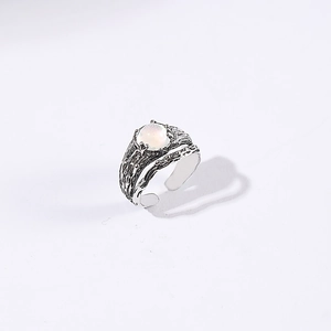 Macro detail of moonstone retro ring with adjustable band and bark textured finish