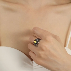 Retro moonstone ring with vintage metal band and iridescent stone on finger