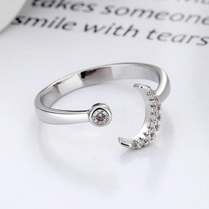 Minimalist moon and star open ring with sparkling crystal accents in bright silver finish