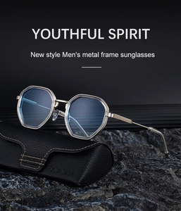 Detail of polygonal sunglasses with blue lenses on a rugged dark stone platform