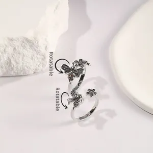 Detailed macro view of spinner bee and daisy ring with vintage oxidized silver finish