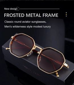 Detail of matte gold polygonal sunglasses with tinted brown lenses and metal temples