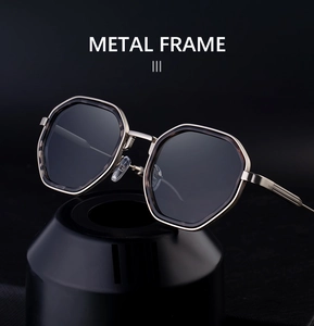Detailed close-up of octagonal gold metal frame sunglasses on a sleek black pedestal