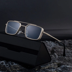 Steampunk gold metal square frame sunglasses with dark lenses on a luxury leather case