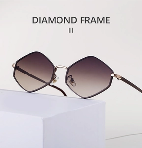 Detail of diamond frame sunglasses with brown gradient lenses and gold metal frames