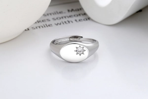 Detail of minimalist silver star ring featuring a sparkling zircon in an octagonal setting