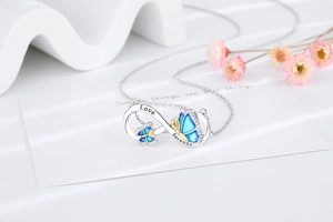 Close-up of infinity butterfly pendant with Love forever engraving and blue enamel
