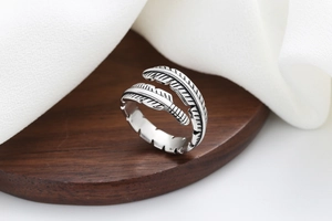 Macro detail of retro feather ring showing intricate textures and vintage oxidized silver finish