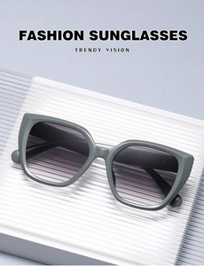 Detail view of fashion cat-eye sunglasses with gradient purple lenses and olive green frame