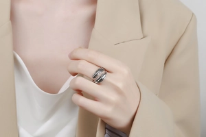 Detail of vintage silver feather ring showing intricate texture and adjustable open band
