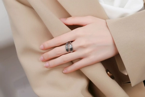Detailed close-up of retro silver feather ring with intricate carved textures