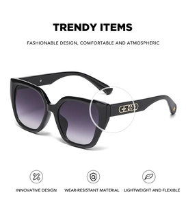 Detail of cat eye sunglasses with purple gradient lenses and gold floral temple accents