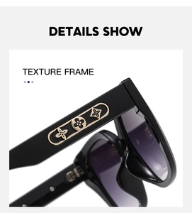 Close-up of wide black sunglasses temples featuring golden clover pattern metal details