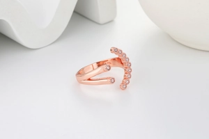 Macro shot of rose gold S925 sterling silver ring with curved cubic zirconia stones