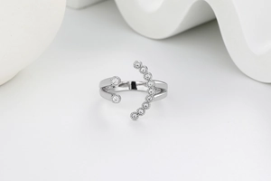 Macro detail of silver smiley face ring with sparkling white cubic zirconia stones