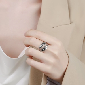 Vintage oxidized silver feather ring with adjustable open design shown on a hand
