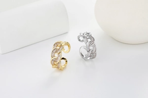 Close-up of Cuban chain rings with baguette-cut zircons in gold and silver finishes