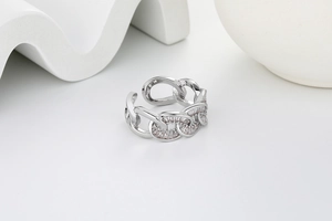 Macro view of interlocking silver chain ring with pave-set shimmering crystals