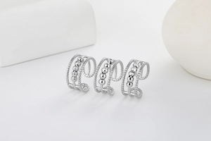 Macro detail of three silver fidget rings with spinning beads and twisted rope texture