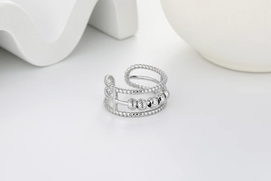 Detail of silver triple layer spinning bead ring with textured bands for stress relief