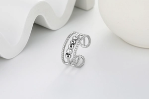 Detail view of silver triple-layer textured band ring with four movable beads