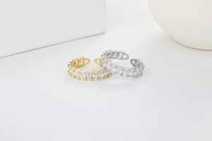 Macro shot of gold and silver open rings with pavé set oval cubic zirconia crystals