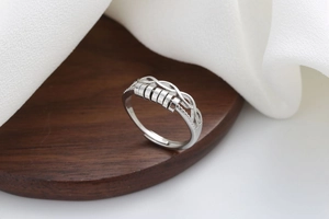 Close-up of silver anti-anxiety spinning ring with rotating beads and braided detail